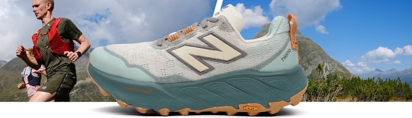 New Balance Hierro V9 trail running shoe in grey and mint with Fresh Foam X midsole and Vibram outsole, mountain background