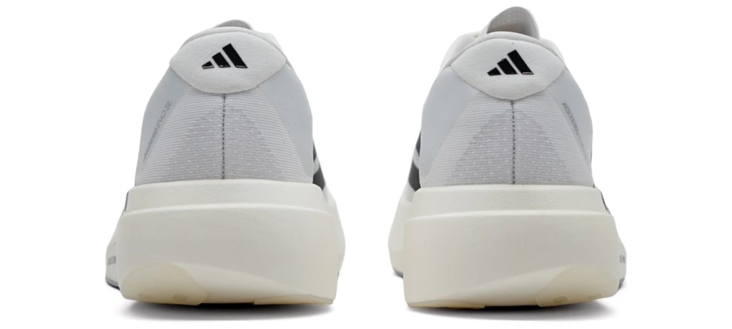 Rear view of two Adidas Adizero Evo SL running shoes in light grey with a cream-white midsole and black logo