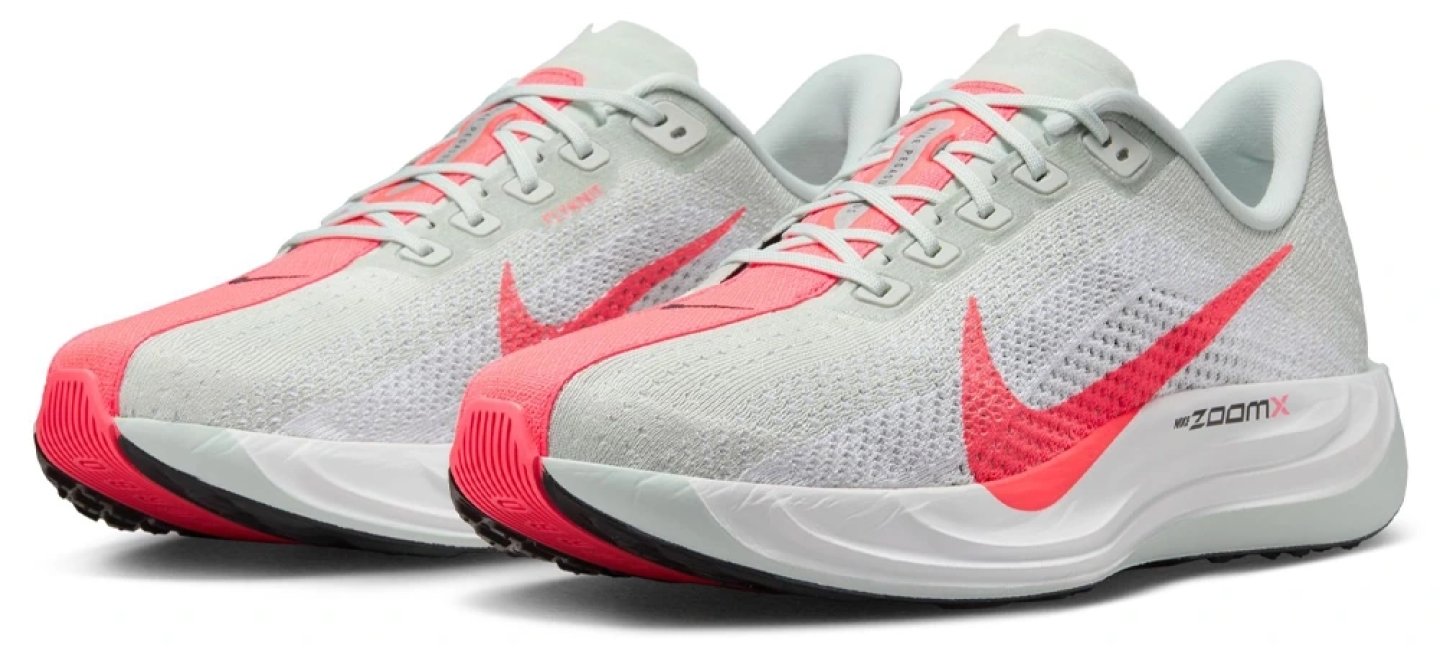 Nike Pegasus Plus running shoe in light silver with hot coral Swoosh and ZoomX midsole, shown as a pair