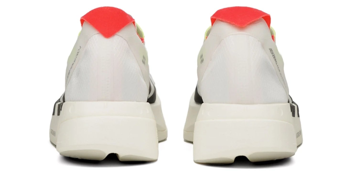 Rear view of the Adidas Adizero Adios Pro 4 in white with a red heel pull tab and cream midsole, shown as a pair.