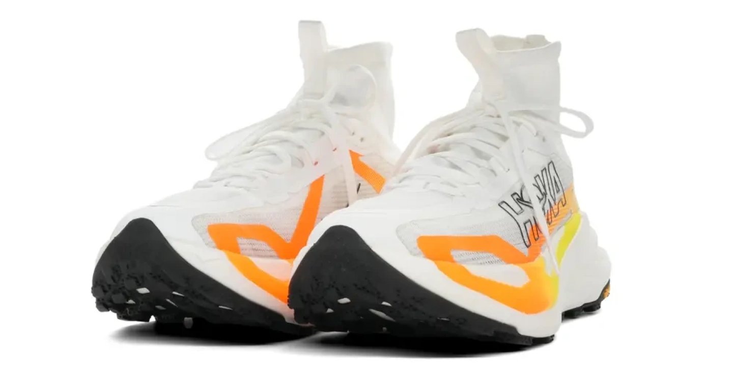 Hoka Tecton X 4 trail running shoes in white and orange with high sock collar and black lugged outsole