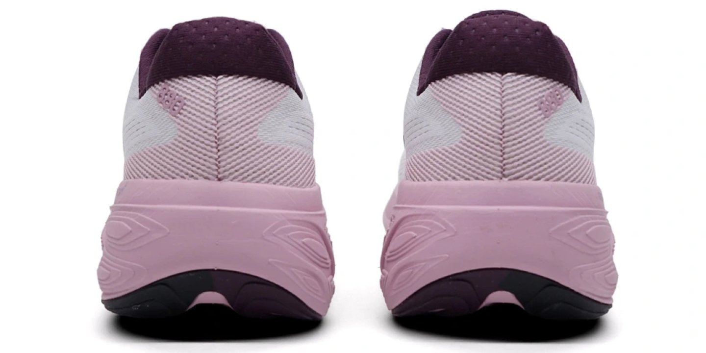 Rear view of two New Balance 880v15 running shoes in pink and purple, showing heel collar, knit upper, and thick midsole.