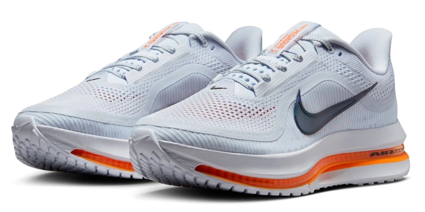 Nike Pegasus Premium running shoe pair in light grey and white with orange Air Zoom midsole stripe, front three-quarter view