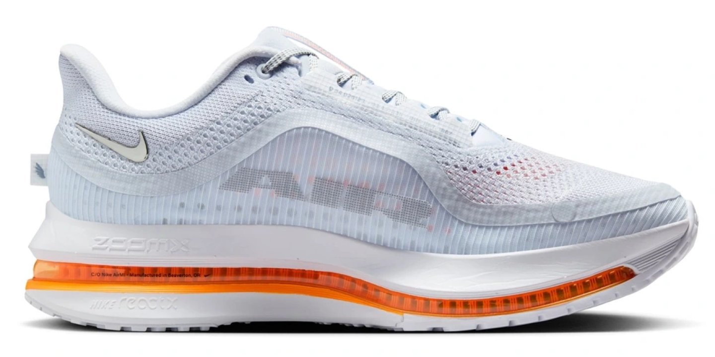 Nike Pegasus Premium running shoe inner side view, white mesh upper with orange Air unit midsole and ZoomX branding