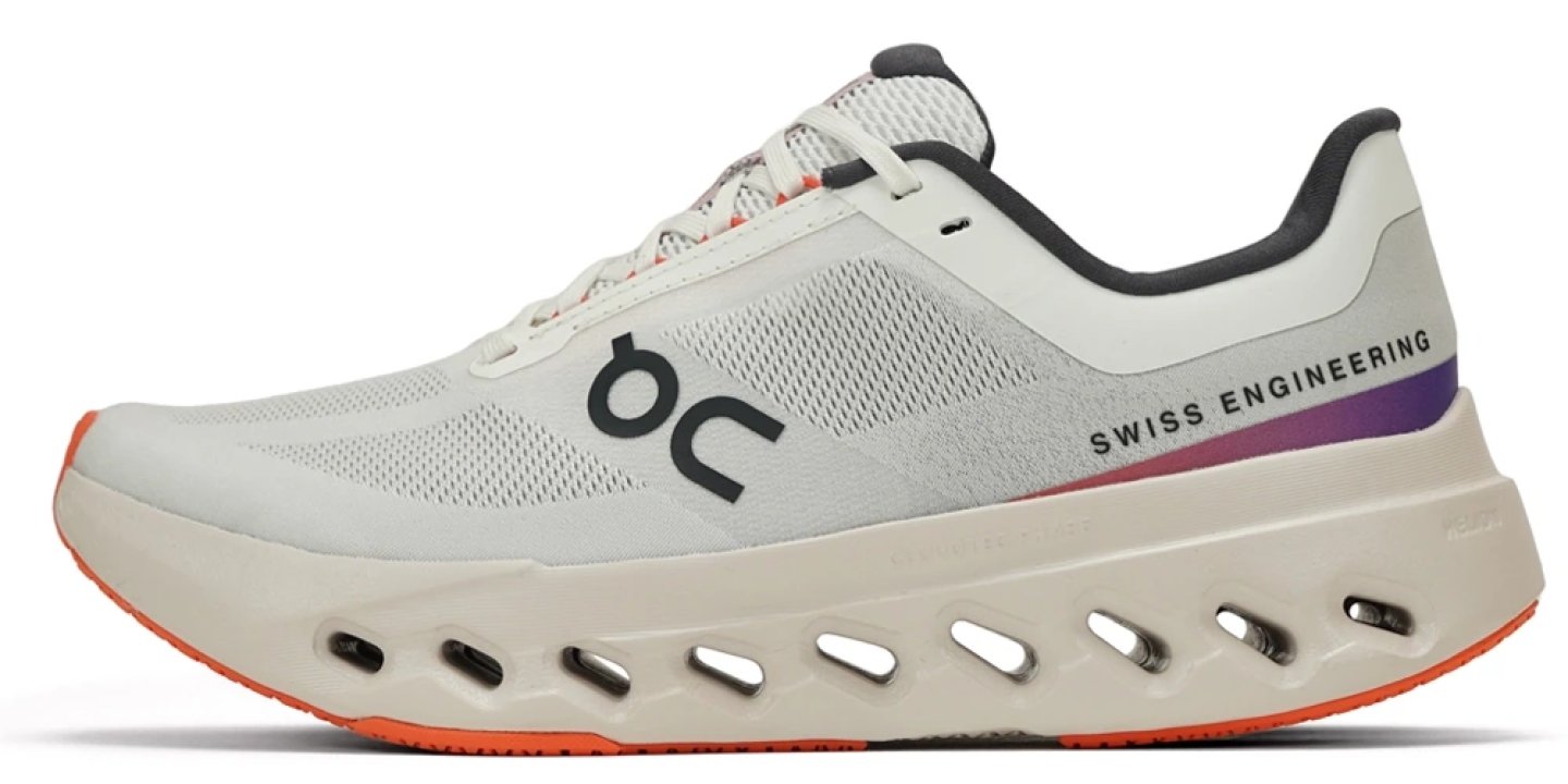 On Cloudsurfer Next running shoe in white with orange outsole and purple heel accent, lateral view