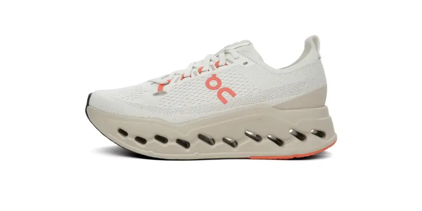 On Cloudsurfer running shoe in white with coral logo and CloudTec midsole pods, lateral side view.