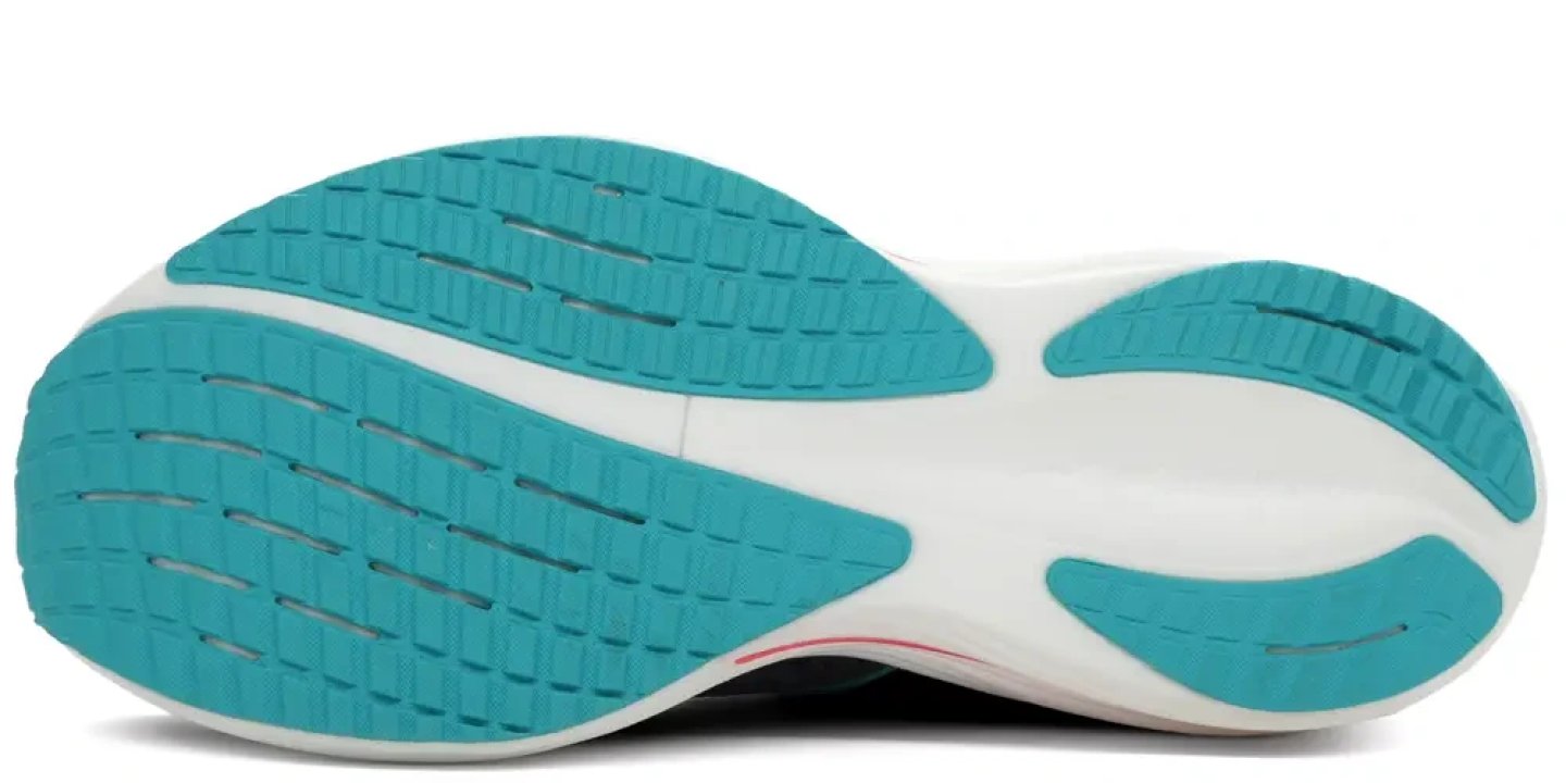 Bottom view of Mizuno Wave Rider 29 running shoe outsole showing teal rubber traction pads and white midsole flex grooves