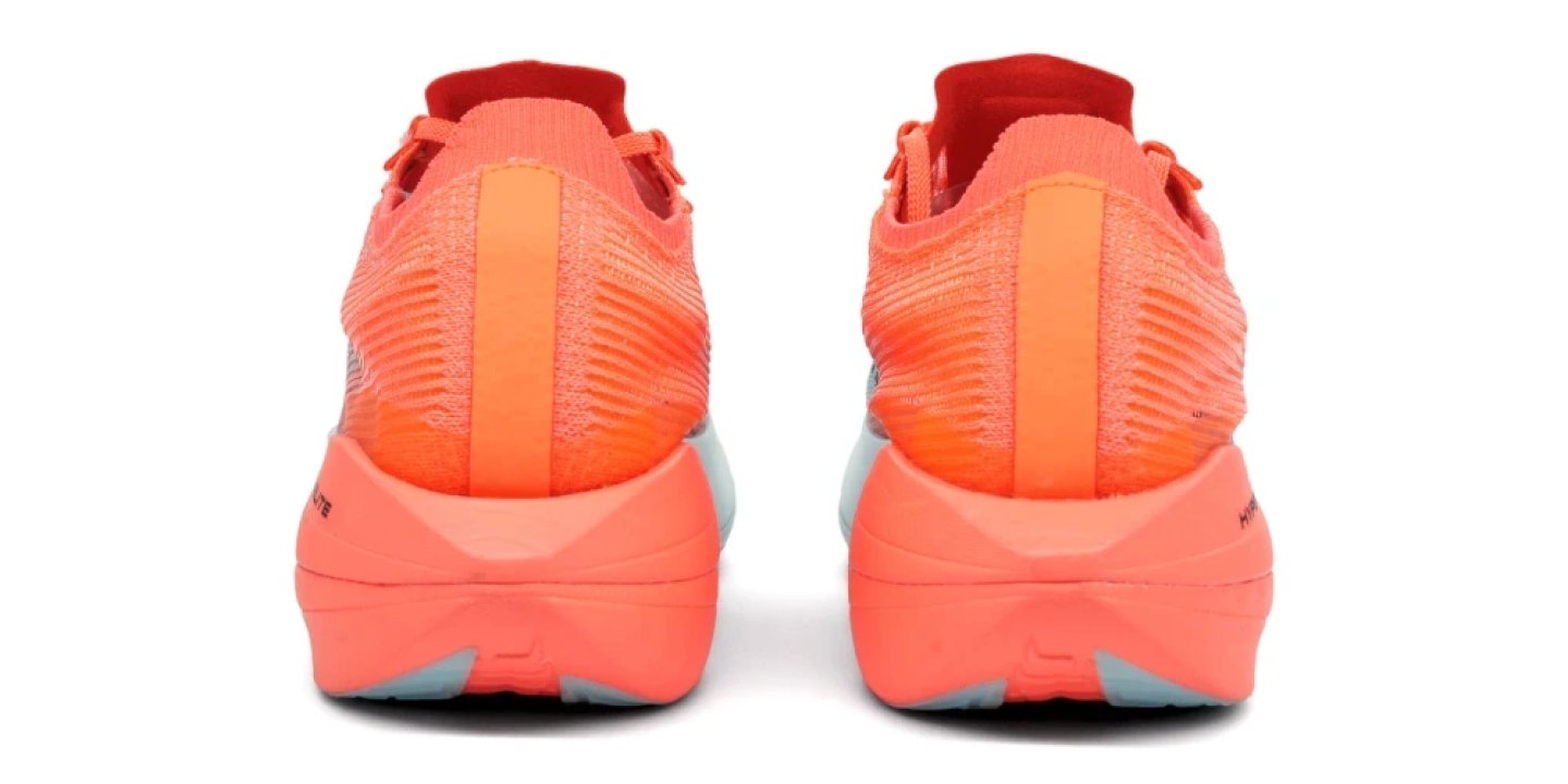 Rear view of a pair of Brooks running shoes in coral orange with knit upper and thick cushioned midsole