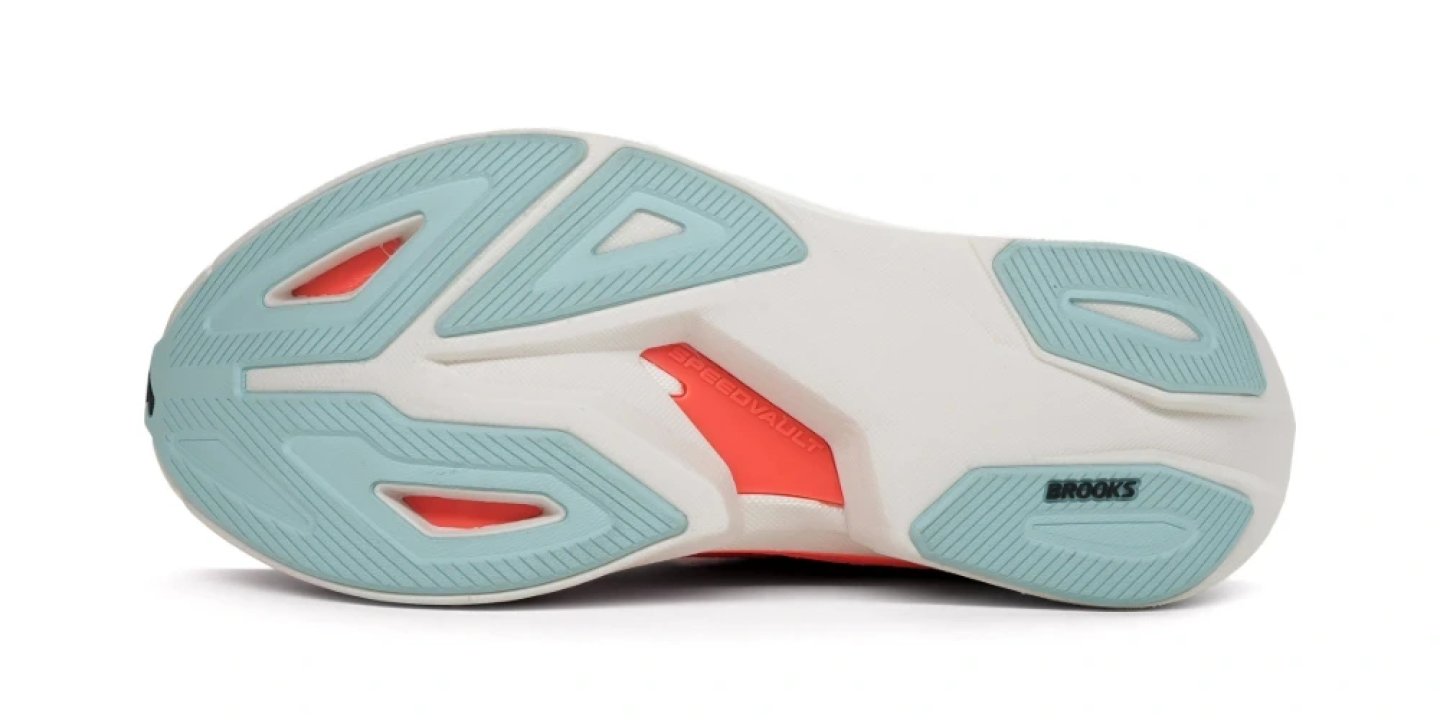 Bottom view of Brooks Speedvault running shoe outsole showing teal rubber pods, coral accents and SpeedVault branding.