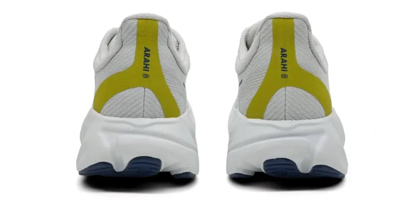 Rear view of two Hoka Arahi running shoes in light grey with yellow heel accents and white midsole with navy outsole